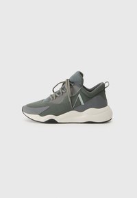 Sport sneakers featuring a mix of dark green mesh and gray accents, with a thick white midsole and gray laces. Rounded toe and padded collar.