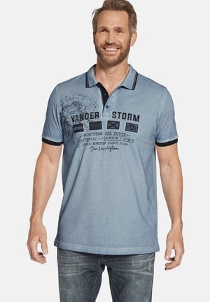 Light blue polo shirt made of cotton, featuring a black collar and cuffs, graphic print with text and flags on the front.