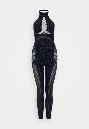 Mono negro con un cuello alto, paneles de malla de red y adornos de pequeños cristales de plata en todo el diseño.
