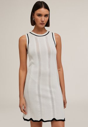 White sleeveless dress featuring a wavy texture, ribbed neckline, and black trim at the hem, creating a contrasting border at the bottom.