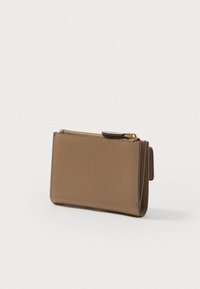 Compact brown leather wallet with gold zipper, featuring embossed logo detail and a smooth texture. Rectangular shape with side slot.