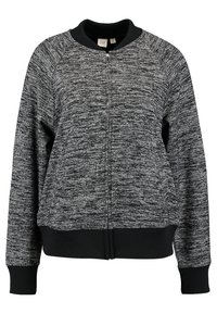 Zwarte en grijze gemarmerde zip-up sweatshirt met een ribbelkraag en ribbels aan de mouwen. Heeft een relaxte pasvorm en een zachte textuur. Eenvoudig, minimalistisch ontwerp.