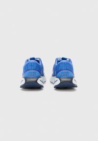 Blue Nike athletic shoes with a textured mesh upper, dark blue accents, and a cushioned sole featuring a distinct white swoosh pattern.