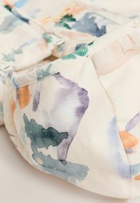 Tela de algodón con un patrón de acuarela en tonos pastel de azul, naranja y verde. Presenta una superficie texturizada y costuras suaves.