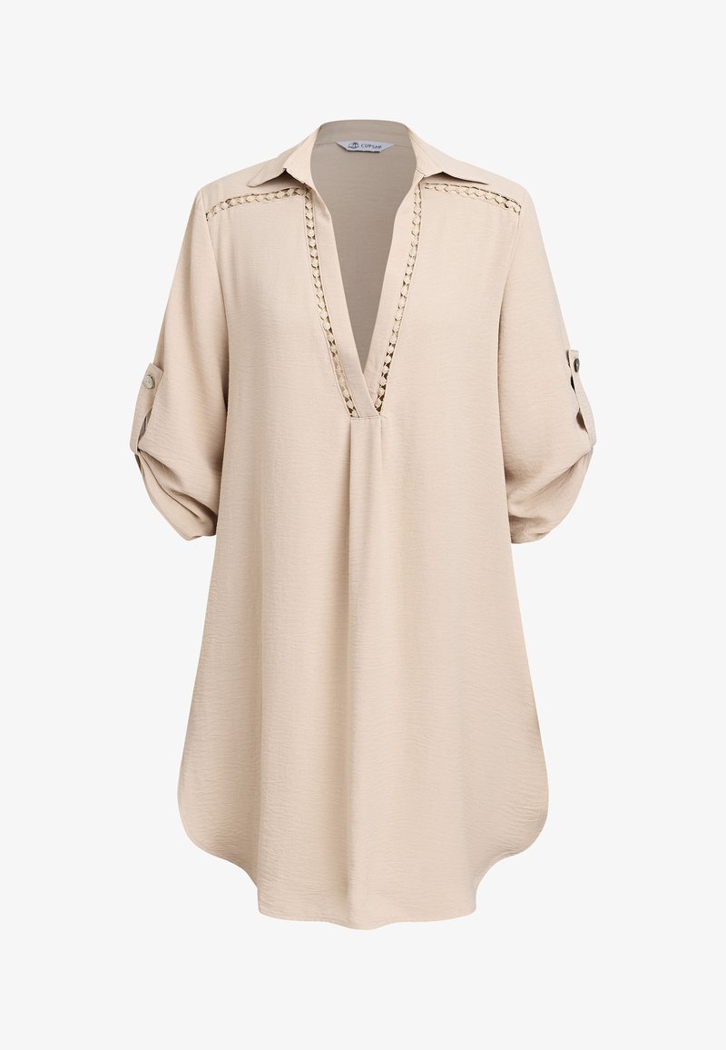 Beige tuniek met lange mouwen, V-hals, gehaakte kanten boord en mouwen met knoopje, gemaakt van gestructureerde stof.