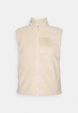 Šviesiai kreminis fliso liemenė su aukštu apykakle, priekiniais užtrauktukais ir lygaus paviršiaus kišene. Taip pat yra dvi šoninės kišenės.