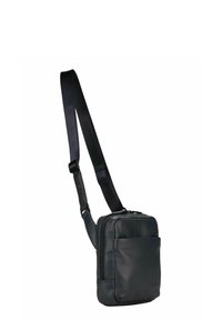 Sac bandoulière en cuir noir avec une sangle réglable, forme carrée, fermeture éclair et poche avant pour un rangement supplémentaire.