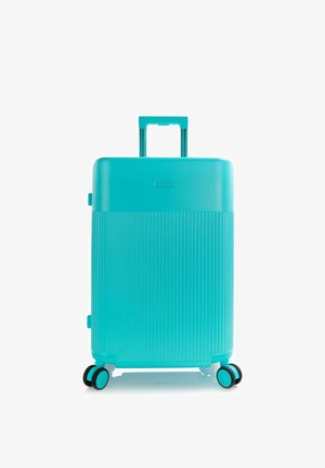 Türkisfarbener Hartschalenkoffer mit vertikalen Rillen, ausziehbarem Griff und vier doppelten Spinner-Rollen.