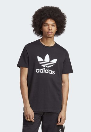 Zwarte katoenen T-shirt met een wit Adidas trefoil logo en tekst. Korte mouwen, ronde halslijn, klassieke pasvorm, soepele textuur.
