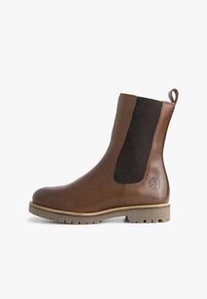 Vaaleanruskea nahkainen nilkkuri, jossa on elastiset verkkopaneelit, pyöreä kärki, teksturoitu kumipohja ja logotyyppi sivussa.