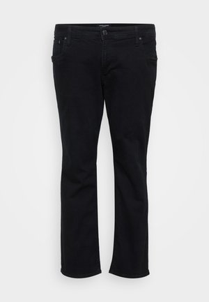 Svarta jeans med smal passform, framknäppning och dragkedja, med fem fickor och bältesöglor, visade mot en vit bakgrund.