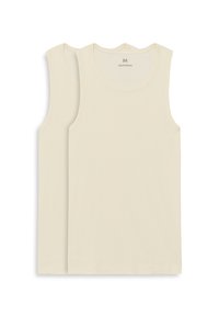 Bavlněná tílka krémové barvy s kulatým výstřihem a bez rukávů, s hladkou texturou a minimalistickým stylem.