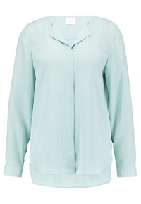 Blusa verde menta clara hecha de una tela suave, con escote en V, mangas largas y un dobladillo curvado con puños abotonados.