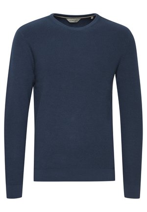 Tumesinine kootud sviiter ümmarguse kaelaaukuga. Omab tekstuurset kangast ning soonikuid varrukaotstes ja allääres. Lihtne ja klassikaline disain.