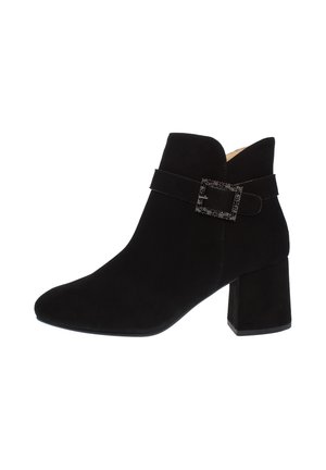 Black suede ankle boot with block heel and decorative square buckle strap on the side.