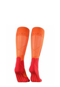 Calze a compressione arancioni e rosse, con un motivo testurizzato e tallone e punta rinforzati. Presentano un bordo superiore a costine per una migliore vestibilità.