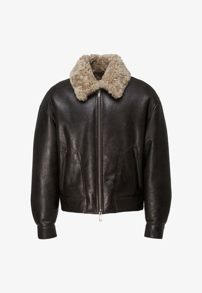Dark brown leather jacket with beige shearling collar, front zipper closure, and zippered side pockets, displayed on white background.