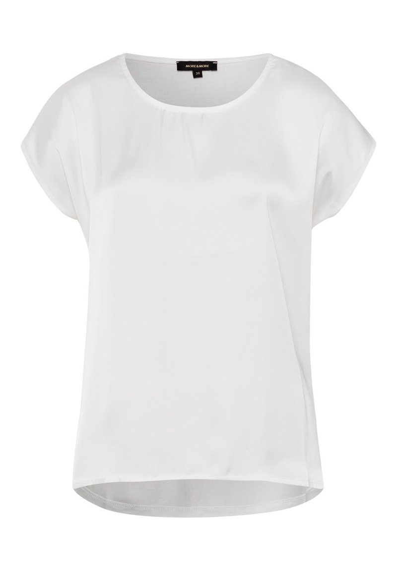 Blusa blanca de manga corta hecha de un tejido suave, con un escote redondo y un dobladillo trasero ligeramente más largo para un ajuste relajado.