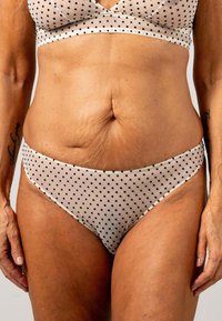 Beige stippen bralette en bikini set gemaakt van zachte, doorzichtige stof met een gladde textuur. Kenmerkt dunne bandjes en een minimalistisch dekking ontwerp.