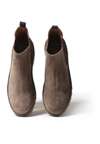 Brown suede ankle boots with elastic side panels; rounded toes; a pull tab on the heel; stitched detailing along the soles. Size 37.