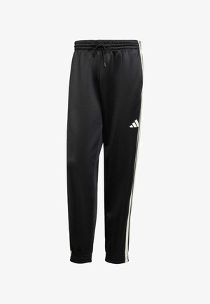 Pantalons de sport noirs en tissu lisse, avec des rayures blanches sur les côtés, une taille élastique avec cordon de serrage, et des poignets ajustés.