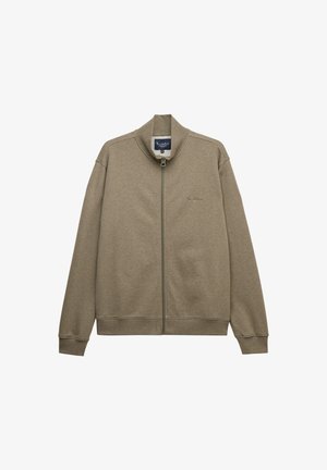 Vetoketjullinen huppari hillityssä oliivinvihreässä, valmistettu pehmeästä kankaasta. Varustettu pystykauluksella sekä ribbireunuksilla hihansuissa ja helmassa varmistaen mukavan istuvuuden.