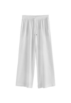 Pantaloni bianchi larghi e ampi con vita elastica e coulisse, realizzati in tessuto leggero.