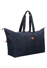 Borsa da viaggio blu navy realizzata in tessuto resistente, con dettagli in pelle beige, due manici robusti e un design spazioso e ben strutturato.
