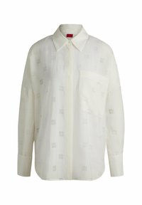 Witte shirt met subtiele patroonstructuur, lange mouwen, een kraag en een borstzak. Bevat het 'HUGO'-logo in lichtgrijs.