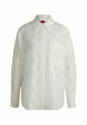 White shirt with subtle patterned texture, long sleeves, a collar, and a chest pocket. Features "HUGO" logo in light gray.