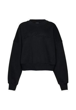 Hanorac negru scurt, cu mâneci lungi și manșete striate, având textul subtil "La Mania" imprimat în relief pe partea din față.