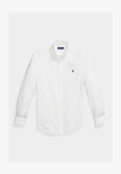 Λευκό πουκάμισο με μακριά μανίκια και κουμπιά, με μπλε κεντημένο λογότυπο παίκτη πολο στην αριστερή πλευρά του στήθους και γιακά με κουμπιά.