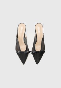 Black pointed-toe mules with a transparent mesh side, featuring a bow accent on the front and a beige insole with the brand name "RAID."