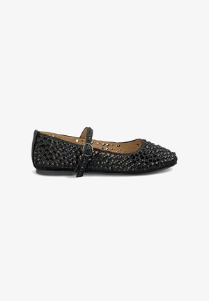 Black ballet flat with a perforated design, featuring a strap with a buckle and a flat sole. The upper is textured and glossy.