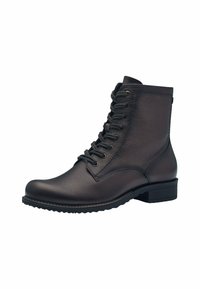Stivale alla caviglia in pelle marrone con una texture liscia, design con lacci e suola in gomma, dotato di un modestissimo tacco a blocco e dettagli di cucitura discreti.