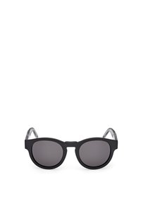 Gafas de sol redondas negras con acabado mate, lentes oscuros y patillas de plástico transparente. Diseño minimalista sin logotipos ni patrones visibles.