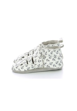 Zapatos blancos para toddlers con un estampado de anclas azul marino, que cuentan con un upper de textura suave, doble correas de Velcro y una suela de ante gris.
