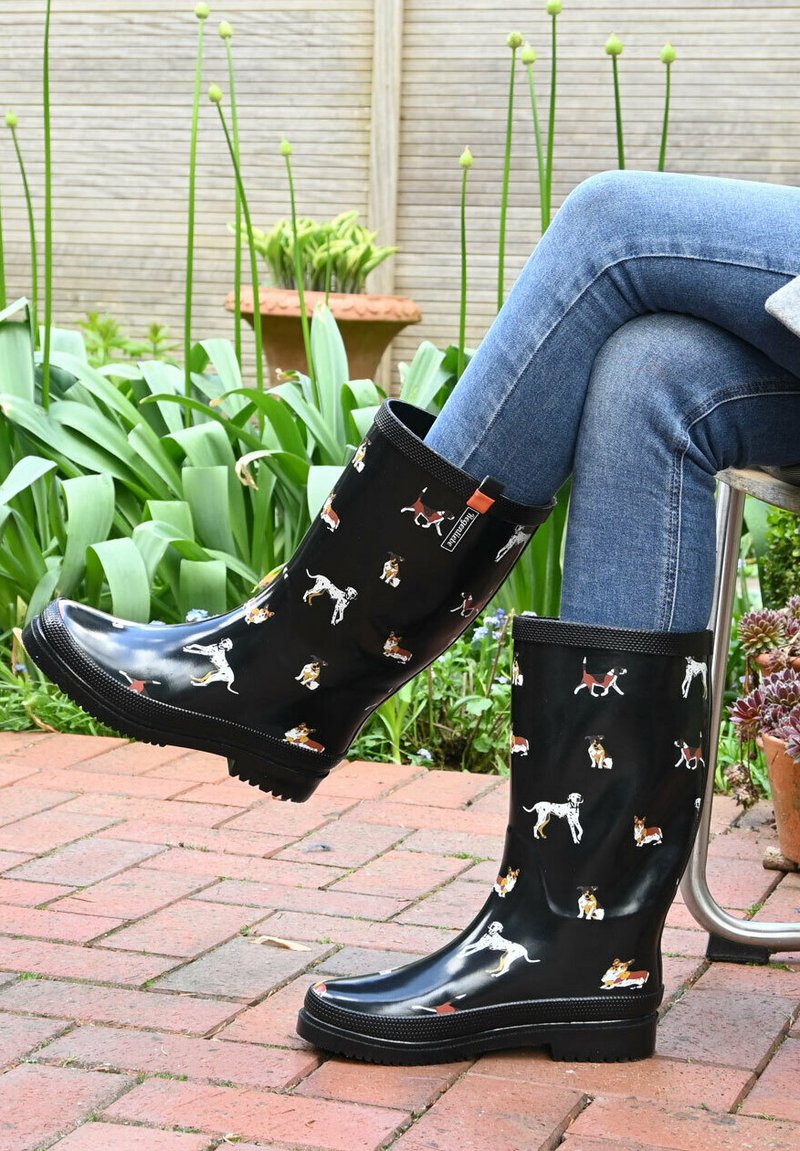 Black waterproof rubber rain boots featuring a dog pattern in various colors, with a textured sole and a cushioned lining for comfort.