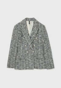 Blazer croisé en tweed noir et blanc, présentant une finition texturée et de grands boutons en perle en accents.