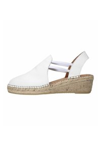 Chaussure compensée en cuir blanc avec des sangles élastiques, semelle en jute et bout arrondi. Texture lisse, talon bas pour plus de confort.