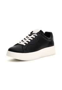 Zapatilla de cuero negro con suela de goma blanca, cordones planos y marca en relieve. Punta redondeada y textura suave.