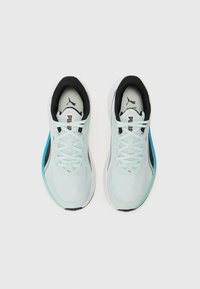 Baskets de sport bleu clair avec tige en mesh, accents noirs au col et au talon, semelle intermédiaire blanche et lacets. Présente un petit logo sur la languette.