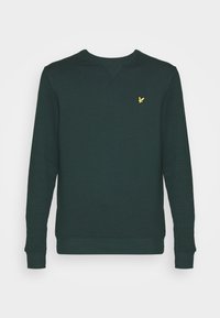 Sudadera verde oscuro hecha de material suave, con un cuello redondo, puños de canalé y un pequeño logo amarillo en el lado izquierdo del pecho.