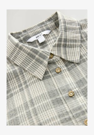 Checkered button-up shirt with a light beige and dark gray plaid pattern, made from soft fabric, featuring a fold-down collar and wooden buttons.
