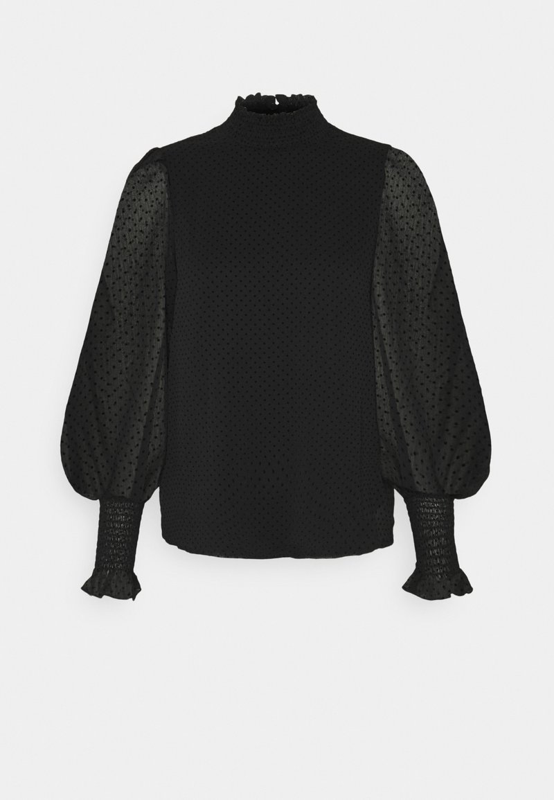 Blouse noire à manches longues avec manches bouffantes transparentes, texture à pois, col haut à volants et poignets smockés à volants.