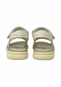 Sandali beige con retro aperto e cinturini regolabili. Presentano una suola testurizzata e una soletta liscia e imbottita con accenti di colore chiaro.