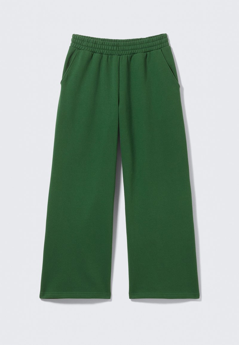Groene, wijd uitlopende joggingbroek met een elastische tailleband en zijzakken. Gemaakt van zachte stof met een gladde textuur. Geen zichtbare patronen.