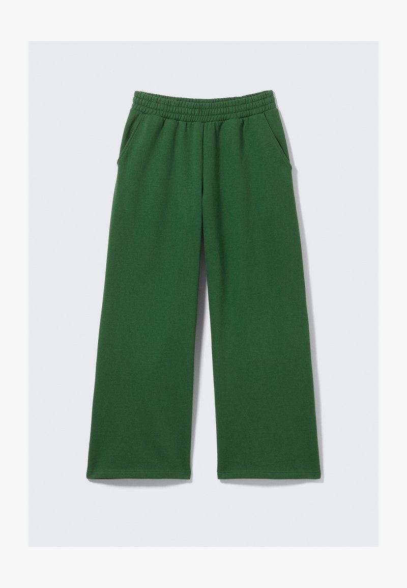 Groene, wijd uitlopende joggingbroek met een elastische tailleband en zijzakken. Gemaakt van zachte stof met een gladde textuur. Geen zichtbare patronen.
