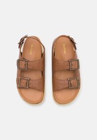 Brown leather sandals with two adjustable buckle straps, textured uppers, and a smooth insole. Features a light, woven sole.