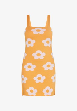 Neulemekko, jossa on tiukka muoto, kirkkaan keltainen väri, suurilla valkoisilla kukkakuoseilla ja leveillä olkaimilla.